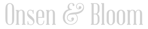 The words "Onsen & Bloom" in a light gray, serif font with a decorative ampersand in the center.